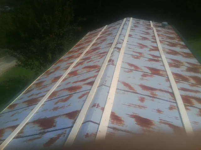 Rusted metal roof panels with new wood purlins before replacement — Storm Damage Roof Repair in Shingletown by Roofing Brothers