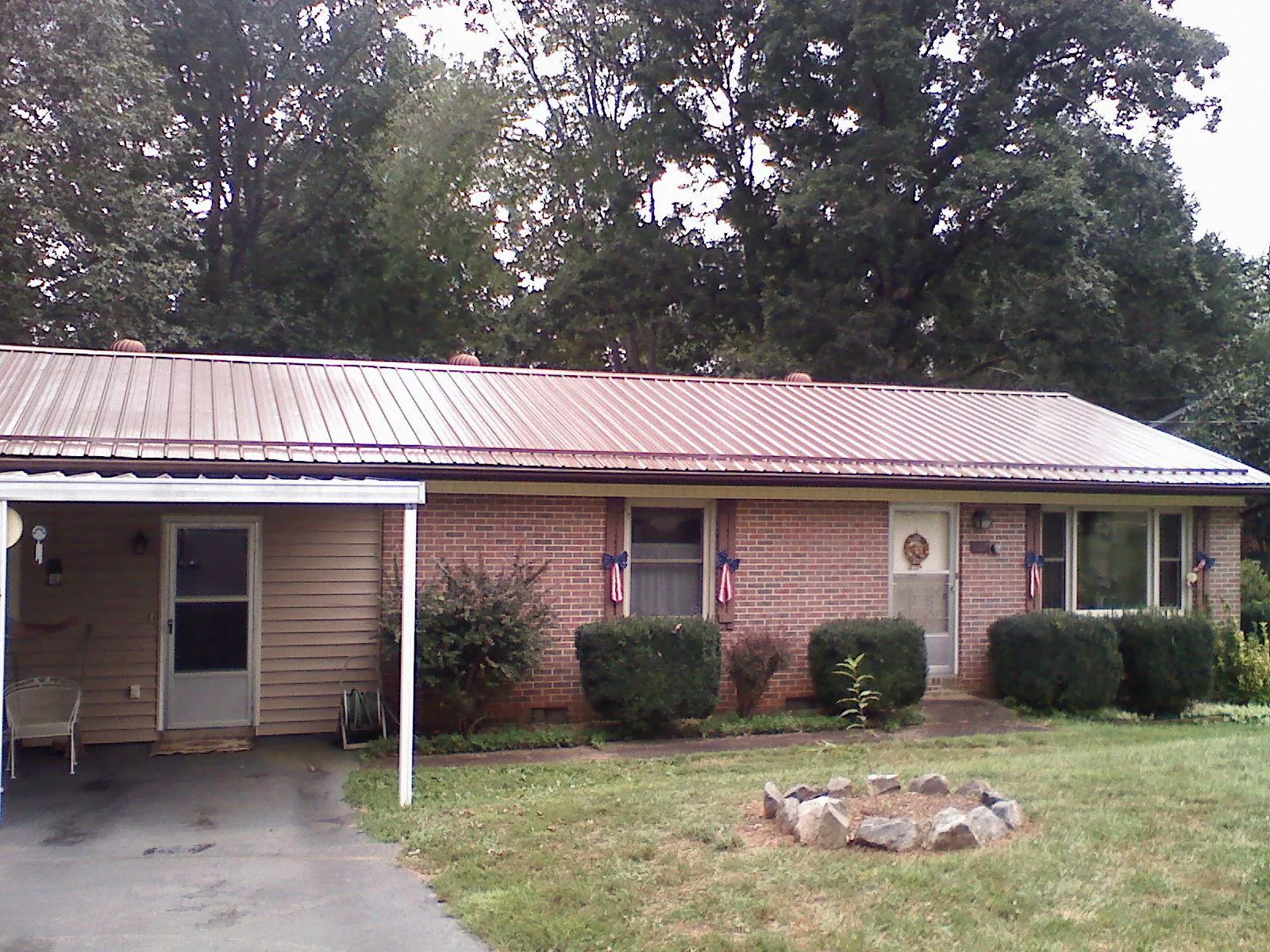 Bronze metal roof and carport on a brick ranch home — Roof Repair work by our crew in Shingletown